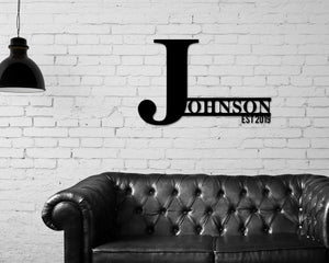 Metal last name sign custom black color hanging on wall
